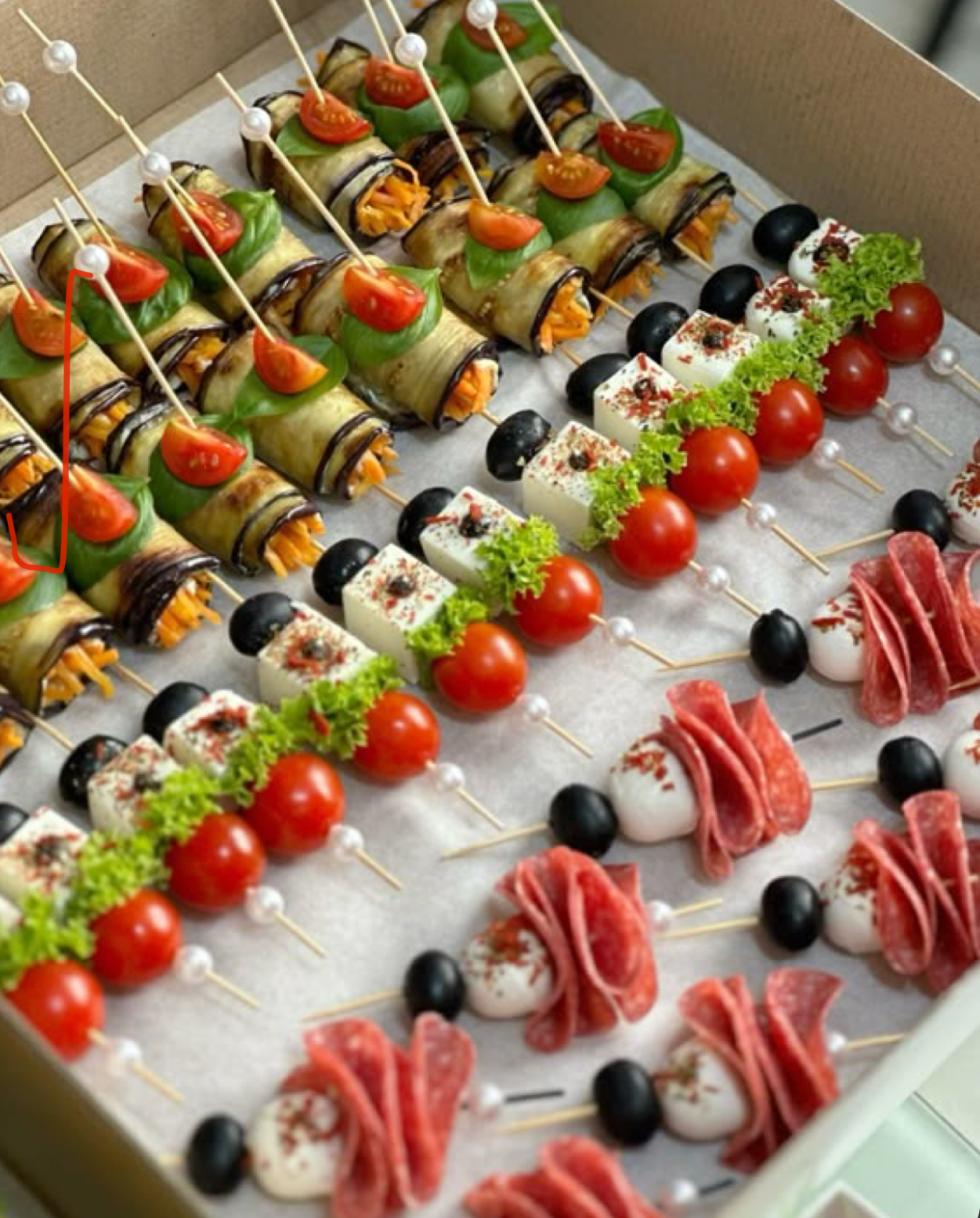 Colorful skewers with olives, cheese, tomatoes, and cured meats.